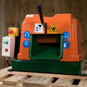 Close-up image of a Sweed CE450DDX strapping chopper machine resting on a wooden pallet