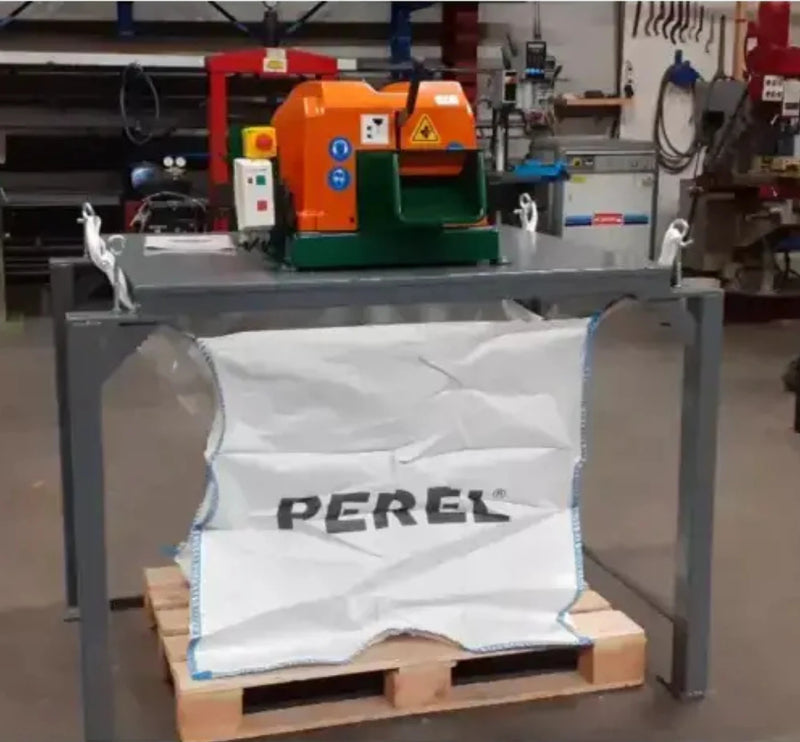 A Sweed CE450DDX pallet strapping on a metal table over a hessian skip bag that is sitting on a pallet in a warehouse