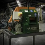 Sweed CE510 Strapping Chopper machine resting on a metal table in a warehouse
