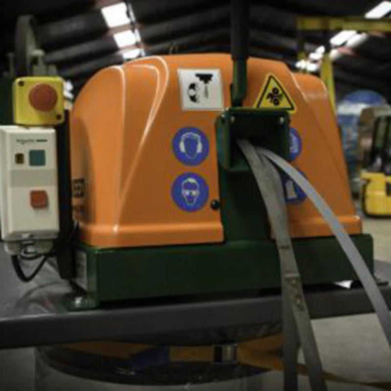 A Sweed CE300 Strapping Chopper being fed with pallet strapping in a warehouse