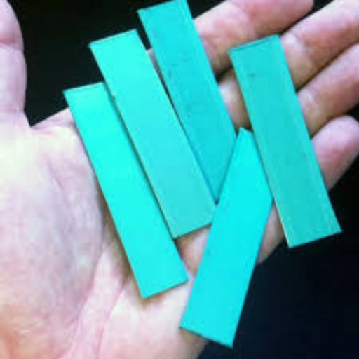 a hand holding pieces of plastic pallet strapping that been cut into small pieces using a Sweed Strapping Chopper