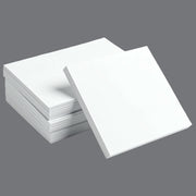 four reams of white packing paper on a grey background