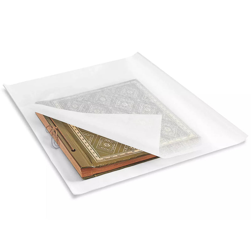 antique book wrapped with acid free tissue on a white background