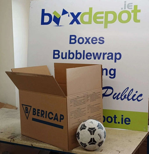 Large Double Wall Cardboard Box beside a football for perspective, in front of Box Depot advertising board.