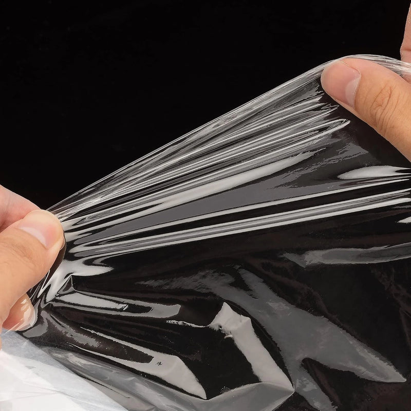 Person stretching some black pallet wrap between his hands