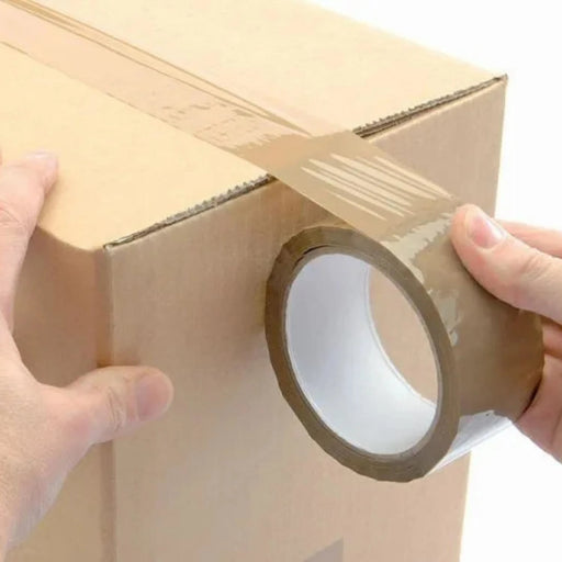 A man sealing a cardboard box using a roll of brown sealing tape