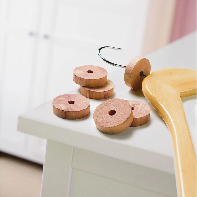 cedar wood moth repellent disks on a bedroom shelving unit beside a hangar