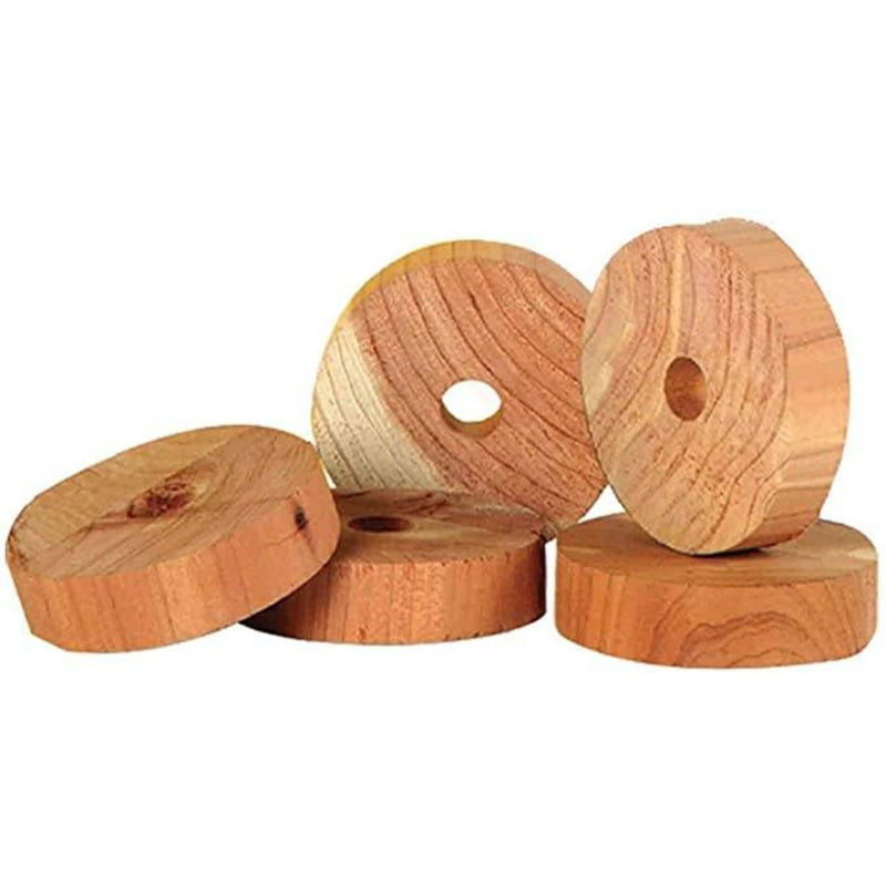 five wooden disks of cedar moth repellent on a white background