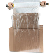 Person wrapping 2cardboard boxes together with clear pallet wrap on a white background