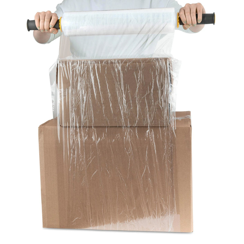 Person wrapping 2cardboard boxes together with clear pallet wrap on a white background
