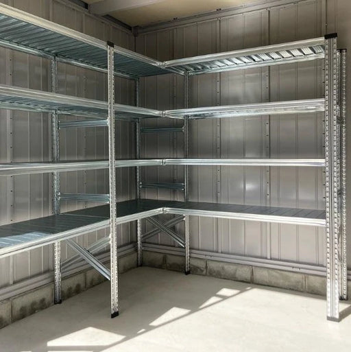 Metal shelving unit in a storage room with concrete floor and walls.