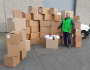 Jumbo Moving Kit assembled in front of the Box Depot Van with a man standing beside them for perspective