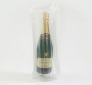 Bottle of champagne in a protective Bubl air cushioning pod on a white background
