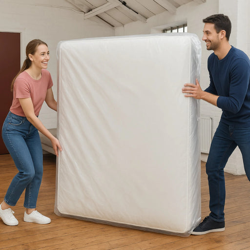 A couple moving a mattress that is covered with a mattress bag