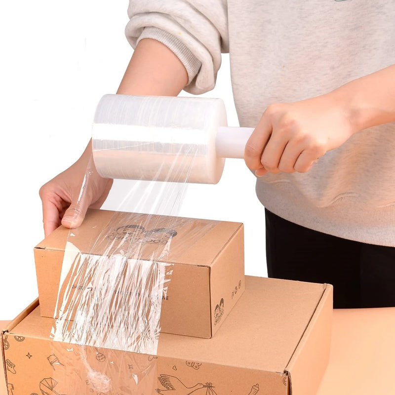 a man wrapping cardboard boxes with mini pallet wrap on a white background