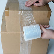 Person wrapping cardboard boxes with mini pallet wrap
