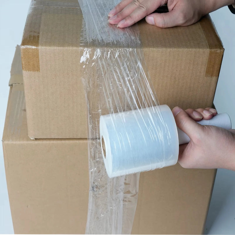 Person wrapping cardboard boxes with mini pallet wrap