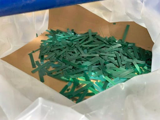 closeup of chopped PET pallet strapping inside a cardboard box