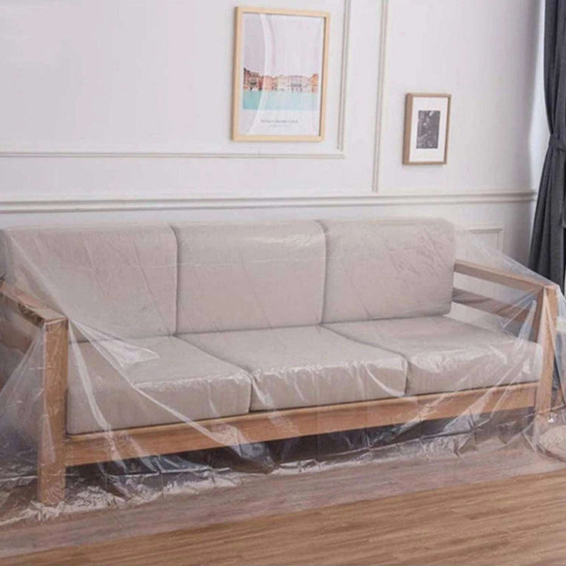 A transparent polythene furniture cover bag being used to cover a 3-seat sofa in a living room