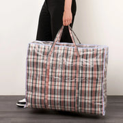 a man with a black and red tartan plastic fabric storage bag on a plain background