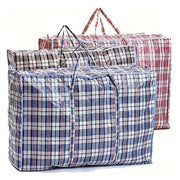 three plastic fabric large storage bags in blue, black and red tartan on a white background