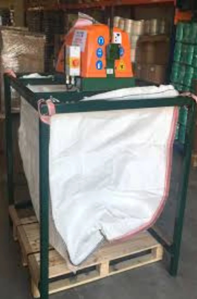 A Sweed CE300 strapping chopper machine on a stand with a hessian bag below to catch the chopped pallet strapping in a warehouse