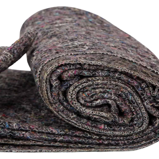 closeup of a rolled up furniture transit blanket on a white background