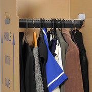 clothes hanging on the rail of a cardboard wardrobe box