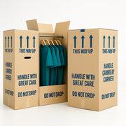 Three cardboard wardrobe boxes. One of the boxes is open to show clothing on hangars within the box.