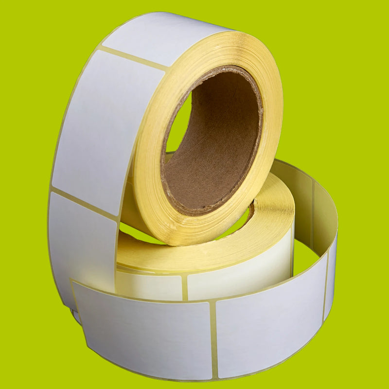 Two rolls of white labels on a green background