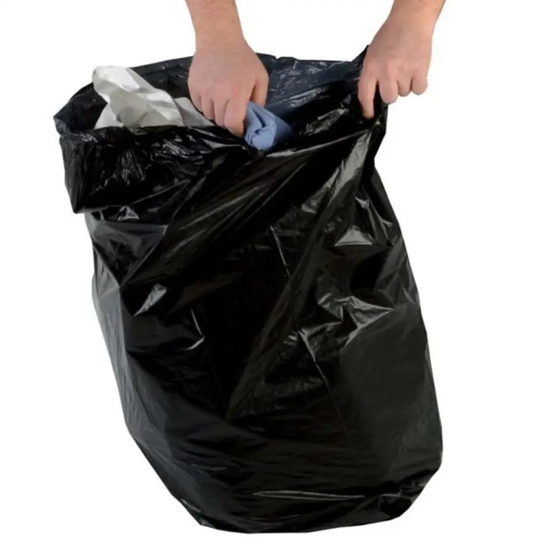 a hand putting rubbish into a large black bin bag on a white background