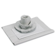 Images of plates and cups wrapped in white packing paper on a white background